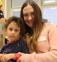 student and adult smiling