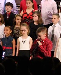 student speaking at winter concert