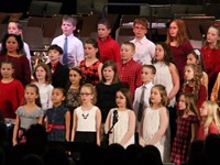 medium shot of students singing at winter concert