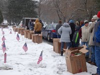 people lined up near boxes