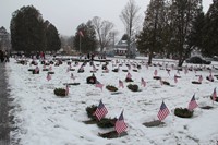 veterans graves with wreaths on them and flags next to them