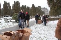 wide shot of cemetary with people standing in background