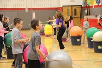 teacher dancing down middle of drums alive activity