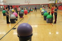 wide shot of drums alive with students facing partners