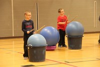 two boys standing holding drum sticks