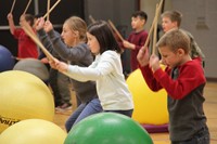 multiple students holding up drum sticks