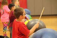 student holding up drum stick