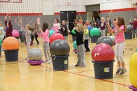 wide shot of students holding drum sticks