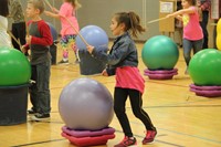 student dancing holding drum stick