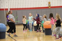 medium shot of teachers and students dancing