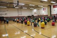 another wide shot of drums alive in gymnasium