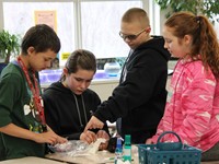 students mummifying doll