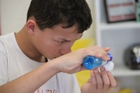 student putting water on cotton swab