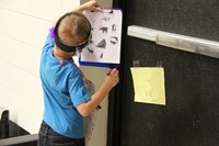 student looking at scavenger hunt sign