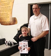 two people smiling with scavenger hunt paper