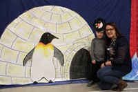 two people standing next to penguin illustration