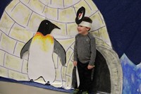 another student standing next to penguin illustration