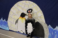 student standing next to penguin illustration