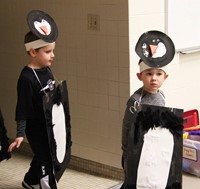 two students with penguin costumes on