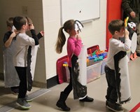 additional students dressed in penguin costumes