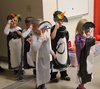 more students dressed in penguin costumes