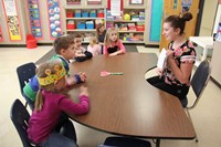 high school student reading to Port Dickinson Elementary Students