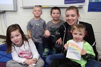 students smiling with book high school student wrote