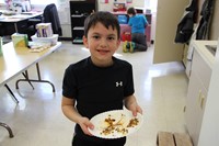 boy holding plate with finished taco