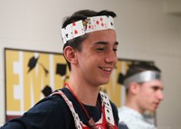 student smiling wearing crown made from playing cards