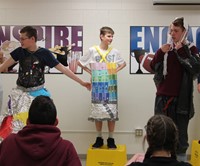 three students dressed in recycled items