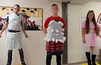 three students dressed up for recycled fashion show