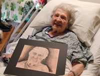 woman smiling with portrait of her