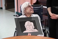 woman looking up holding drawing