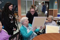 women and students talking about drawings