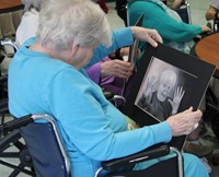 woman sitting looking at drawing