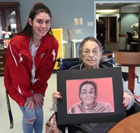 student and woman smiling with picture