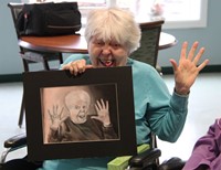 woman posing like her drawing.