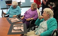 three women looking at drawings