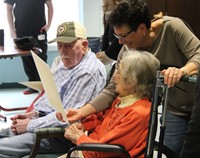 two woman looking at drawing