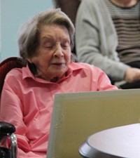 woman looking down at drawing of herself