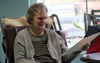 woman looking at drawing of herself