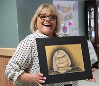 employee smiling with drawing of herself