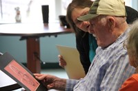 man looking at portrait drawing