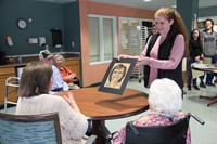 student handing woman drawing