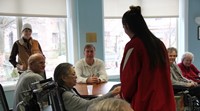 student handing resident drawing