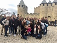 students standing in front of castle