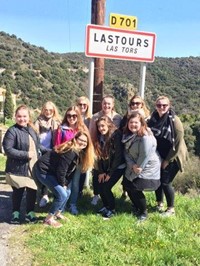 students standing in front of road sign