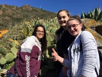 students standing in front of cacti