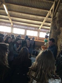 students on tour in barn