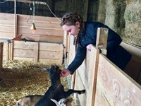 student petting goat